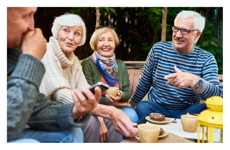 Group of seniors enjoying breakfast on an outdoor patio